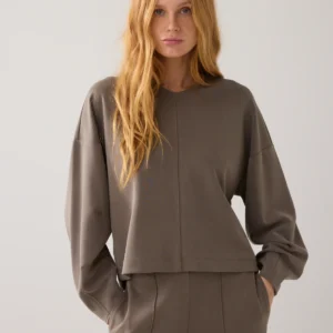 This boxy top is made of a soft modal jersey with a slightly washed finish that creates a matte, chic look. The top has a high V-neck and rounded hems. The rounded back is longer than the front.