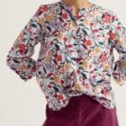 A pretty, relaxed top with feminine details, made from soft and breathable cotton. The notch neck has a functioning singular button and a subtle crossover design, while the dropped hem has curved edges that look great worn loose over trousers. Just add a pair of easy trainers for effortless everyday style. Main Garment:100% Cotton (organic) Relaxed fit Notch neckline Button fastening Certified organic to Global Organic Textile Standards (GOTS) by Soil Association Certification GOTS-11394 Machine Wash 30C