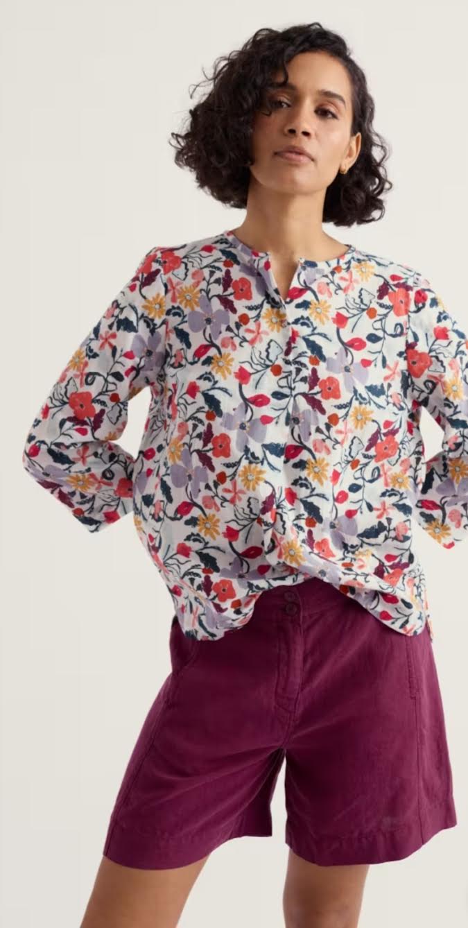 A pretty, relaxed top with feminine details, made from soft and breathable cotton. The notch neck has a functioning singular button and a subtle crossover design, while the dropped hem has curved edges that look great worn loose over trousers. Just add a pair of easy trainers for effortless everyday style. Main Garment:100% Cotton (organic) Relaxed fit Notch neckline Button fastening Certified organic to Global Organic Textile Standards (GOTS) by Soil Association Certification GOTS-11394 Machine Wash 30C